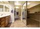 Bathroom with double sinks, large mirror, a closet, and tiled flooring for a clean and modern design at 4202 E Broadway Rd # 223, Mesa, AZ 85206