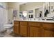 Well-lit bathroom features wood cabinets and neutral-toned decor at 4202 E Broadway Rd # 223, Mesa, AZ 85206