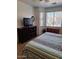 Bedroom featuring a large bed, dresser, TV, and a window with natural light at 4202 E Broadway Rd # 223, Mesa, AZ 85206