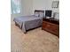 Well-lit bedroom featuring a bed, a dresser with a TV, and a window with natural light at 4202 E Broadway Rd # 223, Mesa, AZ 85206