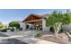 Elegant clubhouse entrance with desert landscaping, wood beams, and covered walkway at 4202 E Broadway Rd # 223, Mesa, AZ 85206