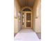 Inviting front entrance with a security screen door, arched window, and desert landscaping at 4202 E Broadway Rd # 223, Mesa, AZ 85206