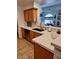 Kitchen features stainless appliances, wood cabinets, and views into the adjacent living area at 4202 E Broadway Rd # 223, Mesa, AZ 85206