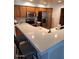 Bright kitchen features wooden cabinets, stainless steel appliances and a large quartz breakfast bar at 4202 E Broadway Rd # 223, Mesa, AZ 85206