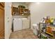 Functional laundry room with washer, dryer, and storage cabinets at 4202 E Broadway Rd # 223, Mesa, AZ 85206