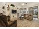 Comfortable living room featuring built-in shelving, a sliding glass door, and neutral tones at 4202 E Broadway Rd # 223, Mesa, AZ 85206