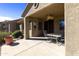 Covered patio with ceiling fan, outdoor seating, and neutral stucco exterior at 4202 E Broadway Rd # 223, Mesa, AZ 85206