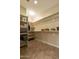 Spacious walk-in closet featuring a large storage space with shelving and tiled floors at 4202 E Broadway Rd # 223, Mesa, AZ 85206