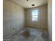 Unfinished bedroom with a bright window providing natural light, ready for personalization at 47706 W Kenner Dr, Maricopa, AZ 85139