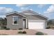 Charming single-story home with gray stucco, white trim, and a two-car garage offers comfortable modern living at 47706 W Kenner Dr, Maricopa, AZ 85139