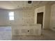 Unfinished kitchen featuring an island, window and spacious layout, ready for customization at 47706 W Kenner Dr, Maricopa, AZ 85139