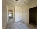 Unfinished spacious living room with drywall, a large window, and natural light at 47706 W Kenner Dr, Maricopa, AZ 85139