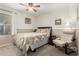 Comfortable bedroom with carpet, neutral walls, a ceiling fan, and a cozy chair with ottoman at 5580 W Kesler St, Chandler, AZ 85226