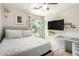 Bright bedroom features a ceiling fan, wall-mounted TV, and natural light at 5580 W Kesler St, Chandler, AZ 85226
