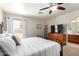 Serene bedroom with neutral walls, large windows, and comfortable furniture, including a wrought iron bed frame at 5580 W Kesler St, Chandler, AZ 85226