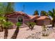 Expansive single-story home boasts a desert-landscaped yard, a terracotta tile roof, and large arched front window at 5580 W Kesler St, Chandler, AZ 85226