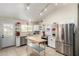 Bright kitchen with white cabinets, stainless steel appliances, a wooden center island, and a vaulted ceiling at 5580 W Kesler St, Chandler, AZ 85226