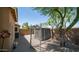 Fenced-in backyard featuring a gravel surface, a shed, and a small tree that provides shade at 7274 W State Ave, Glendale, AZ 85303