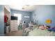 Cozy blue bedroom features a comfortable bed, dresser, vanity, and window offering natural light at 7274 W State Ave, Glendale, AZ 85303
