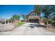 Two-story home featuring a large driveway, well-maintained lawn, a stone wall, and a stone-accented two-car garage at 7274 W State Ave, Glendale, AZ 85303