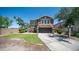 Beautiful two-story home featuring a lush green lawn and a long driveway at 7274 W State Ave, Glendale, AZ 85303