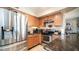 Well-lit kitchen features stainless steel appliances, granite countertops, and warm wood cabinetry at 7274 W State Ave, Glendale, AZ 85303