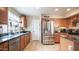 Functional kitchen with granite countertops, stainless steel appliances, and tile flooring at 7274 W State Ave, Glendale, AZ 85303