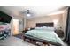 Spacious bedroom with a bed, side table, and additional seating area at 7274 W State Ave, Glendale, AZ 85303