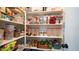 Organized walk-in pantry provides ample storage space with shelves stocked with various food items at 7274 W State Ave, Glendale, AZ 85303