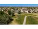 Scenic aerial view of a community with well-maintained homes and a lush green golf course at 8668 N 107Th Dr, Peoria, AZ 85345