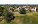 An aerial view of a backyard with mature trees adjacent to a green golf course at 8668 N 107Th Dr, Peoria, AZ 85345
