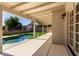 Backyard featuring a covered patio area and kidney-shaped swimming pool at 8668 N 107Th Dr, Peoria, AZ 85345