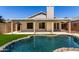 Private backyard oasis with a kidney-shaped swimming pool and covered patio at 8668 N 107Th Dr, Peoria, AZ 85345