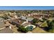 Aerial view of backyard with private pool, lush greenery, and shaded patio area at 8668 N 107Th Dr, Peoria, AZ 85345