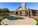 Inviting backyard featuring a kidney-shaped pool, artificial turf, and covered patio at 8668 N 107Th Dr, Peoria, AZ 85345