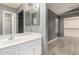 Bright bathroom boasts a white vanity, mirror and doorway to the bedroom and shower at 8668 N 107Th Dr, Peoria, AZ 85345