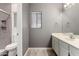 Bathroom featuring a white vanity and tiled walk-in shower with built in shelves at 8668 N 107Th Dr, Peoria, AZ 85345