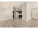 Dining area featuring wood-look floors and stylish chandelier, leading to the kitchen at 8668 N 107Th Dr, Peoria, AZ 85345