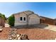 Tan single-story home with desert landscaping, two-car garage and gated side yard at 8668 N 107Th Dr, Peoria, AZ 85345