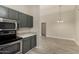 Kitchen with stainless steel appliances, gray cabinets and view into dining area at 8668 N 107Th Dr, Peoria, AZ 85345