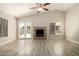 Bright living room featuring high ceilings, brick fireplace, and glass doors to the patio at 8668 N 107Th Dr, Peoria, AZ 85345