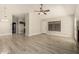 Spacious living room with wood-look flooring and a view to the kitchen at 8668 N 107Th Dr, Peoria, AZ 85345