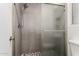 Walk-in shower features neutral tile and a modern rainfall shower head at 8668 N 107Th Dr, Peoria, AZ 85345