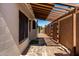 Charming side yard with pergola, stone pathway, and well-maintained landscaping at 8668 N 107Th Dr, Peoria, AZ 85345