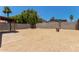 Large backyard featuring a patio and block wall with desert landscaping and shade trees at 934 E Wahalla Ln, Phoenix, AZ 85024