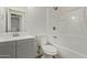 Well-lit bathroom with a neutral color palette, modern fixtures, and a bathtub with shower at 934 E Wahalla Ln, Phoenix, AZ 85024