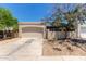 Detached garage with a neutral facade and a concrete driveway surrounded by desert landscaping at 934 E Wahalla Ln, Phoenix, AZ 85024