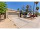 Detached garage featuring desert landscaping and a concrete driveway on a sunny day at 934 E Wahalla Ln, Phoenix, AZ 85024