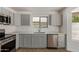 Updated kitchen features modern stainless appliances and light gray cabinets at 934 E Wahalla Ln, Phoenix, AZ 85024