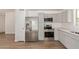 Bright kitchen with stainless steel appliances, gray cabinets, and wood-look flooring at 934 E Wahalla Ln, Phoenix, AZ 85024